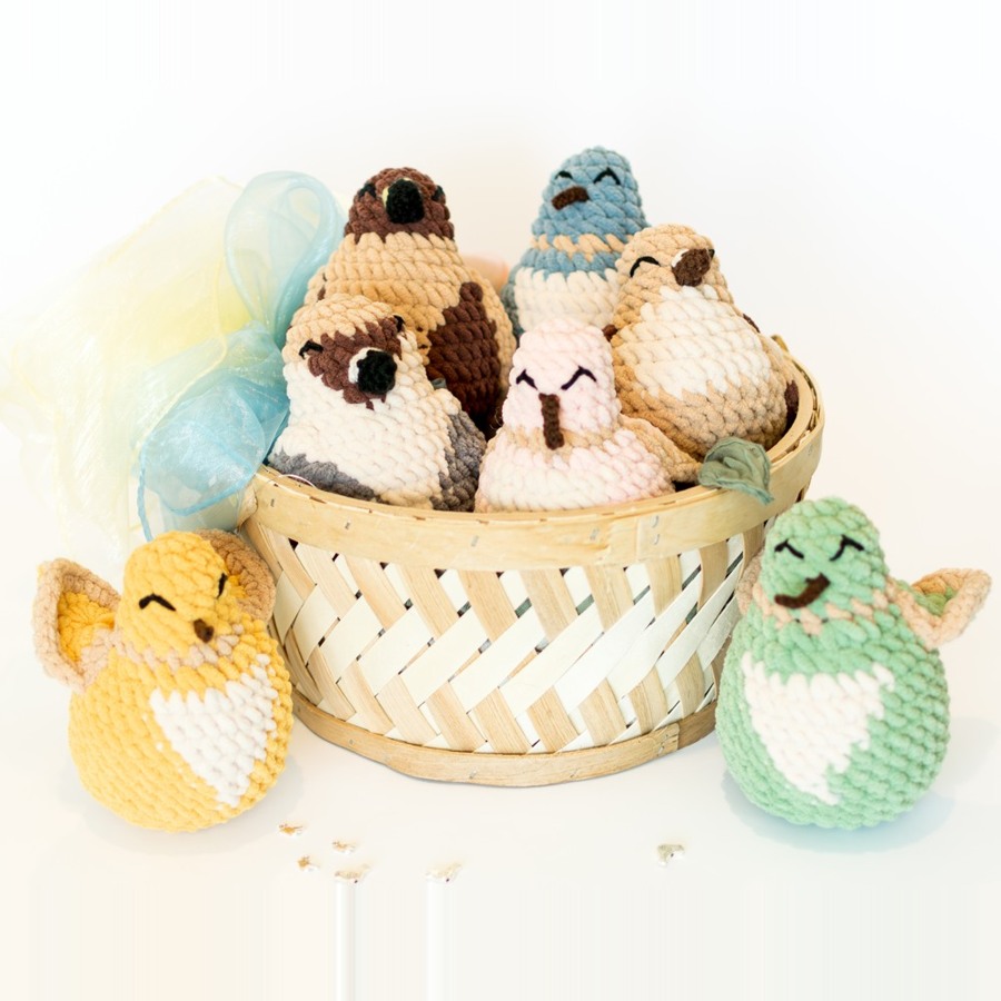 hand-crocheted bird stuffies in a basket
